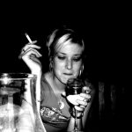 Girl craving alcohol and smoking a cigarette