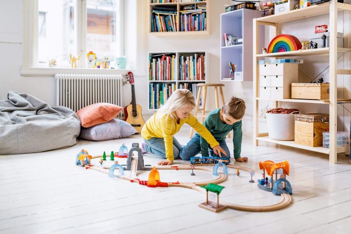 Kids playing with Brio trains on the floor, Kids room