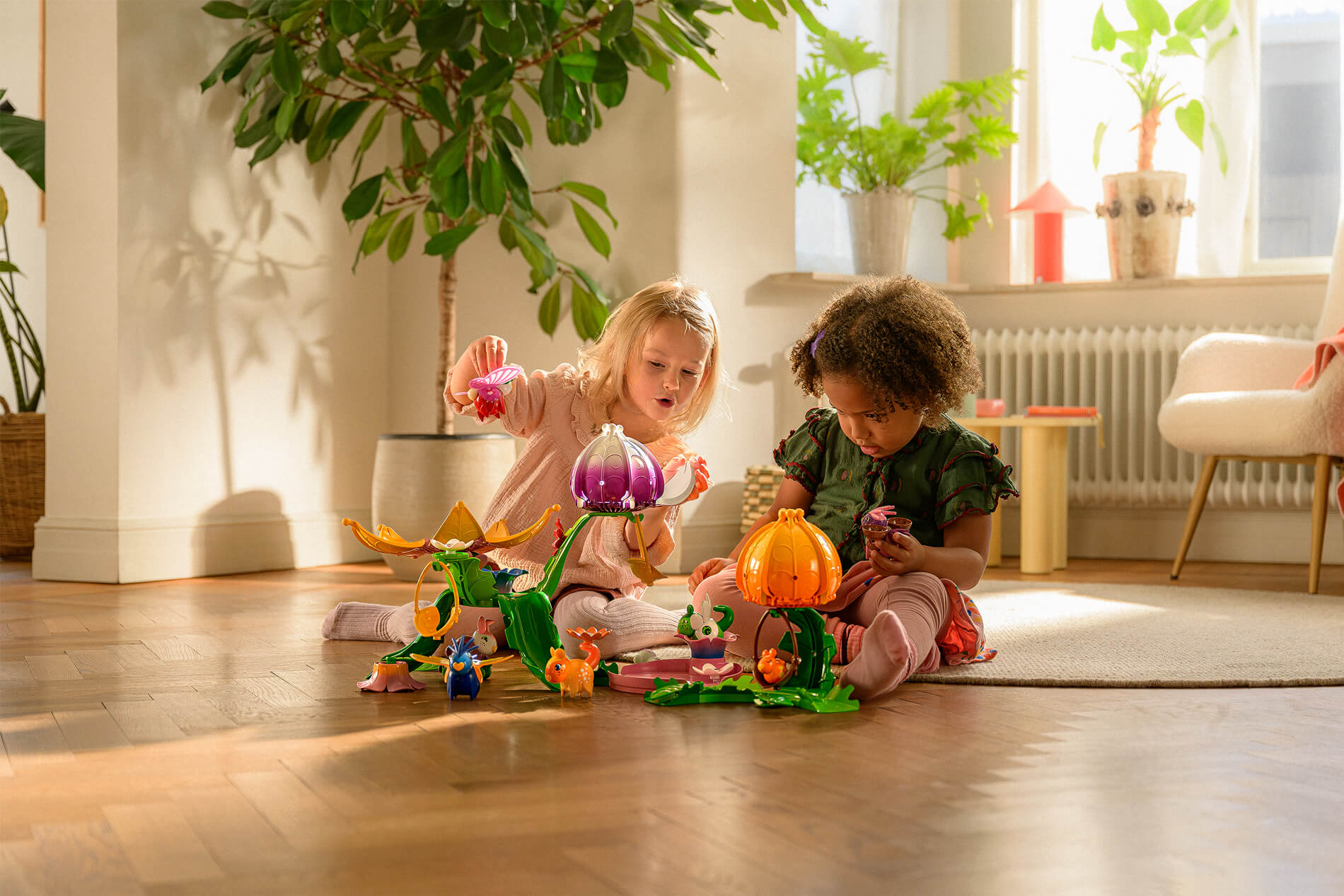 Kids playing with toys on the living room floor. Soft evening light through window.