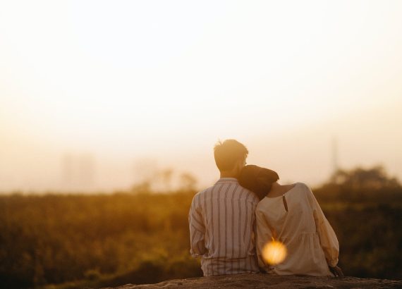 man and woman near grass field