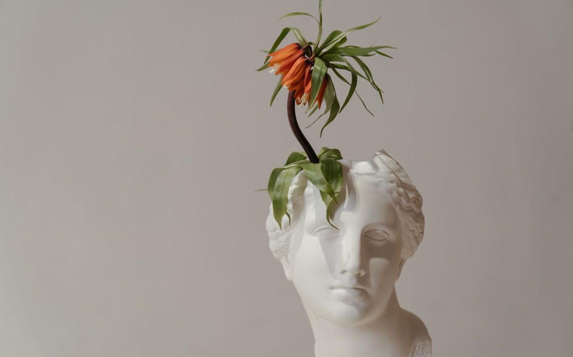 white ceramic woman with red flower