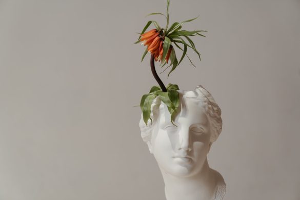 white ceramic woman with red flower