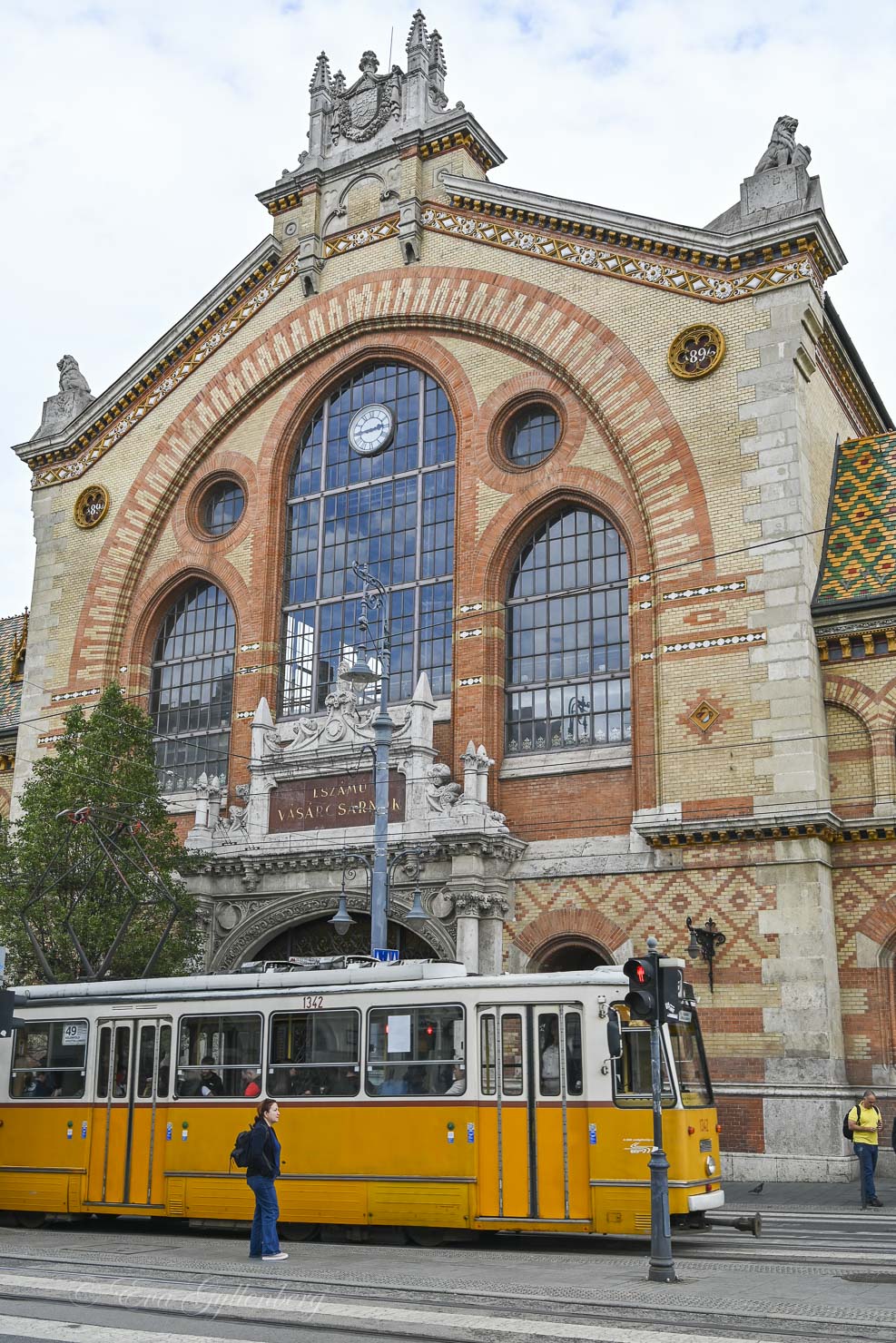 Food market in Budapest with a yellow tram outside