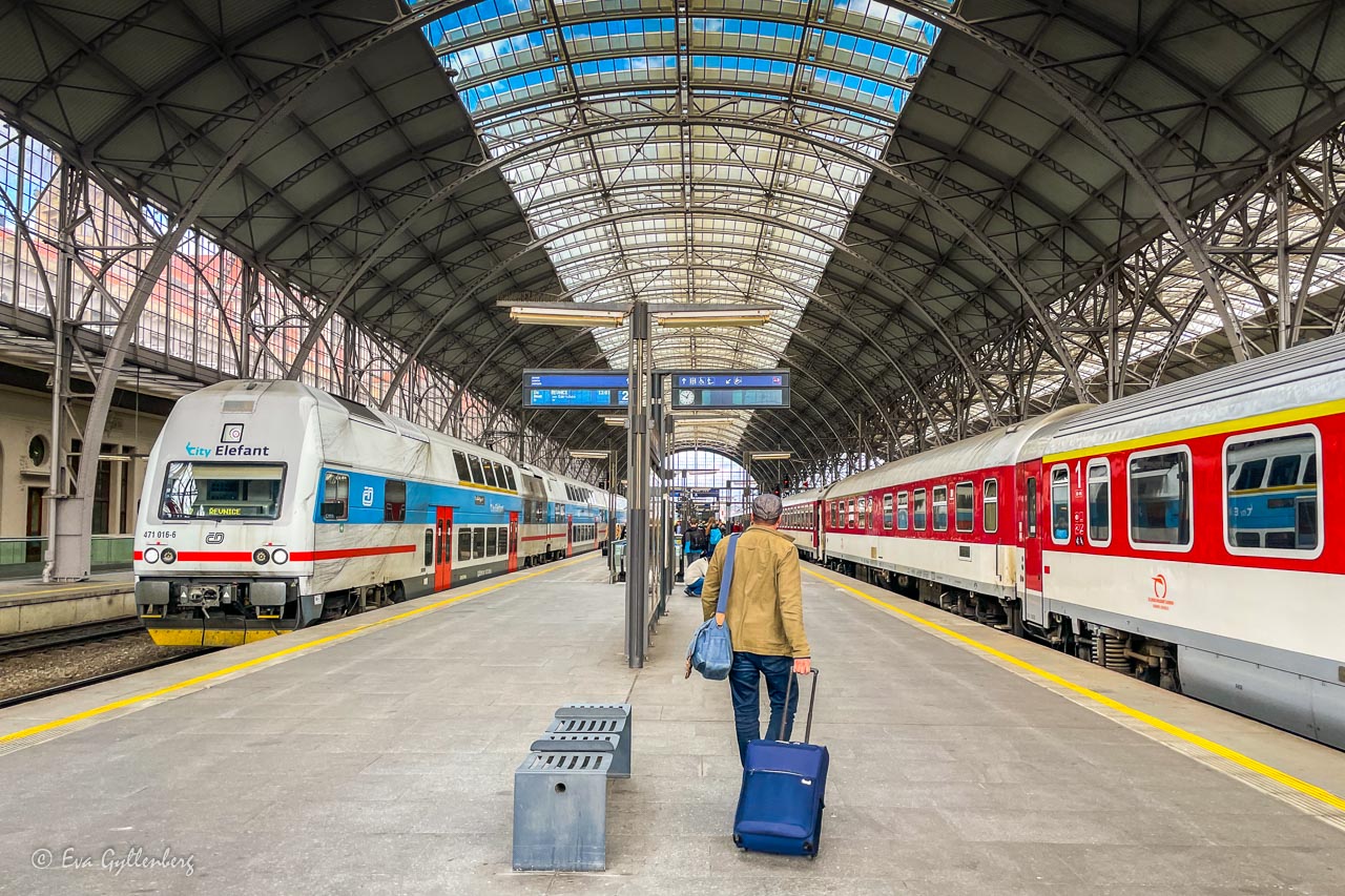 The train station in Prague with two trains - a place where you often start traveling by train in the Czech Republic