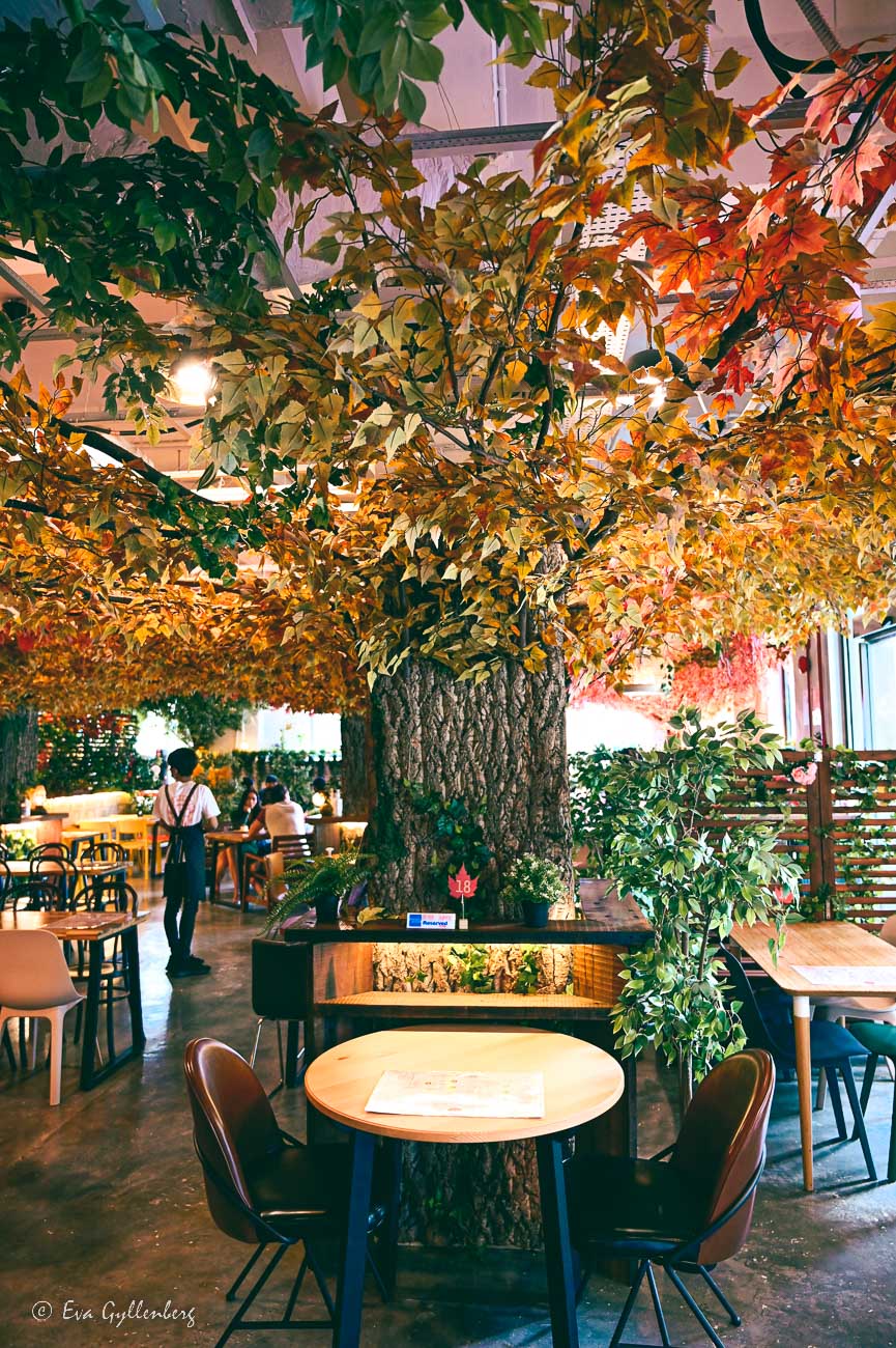 an artificial tree inside a cafe