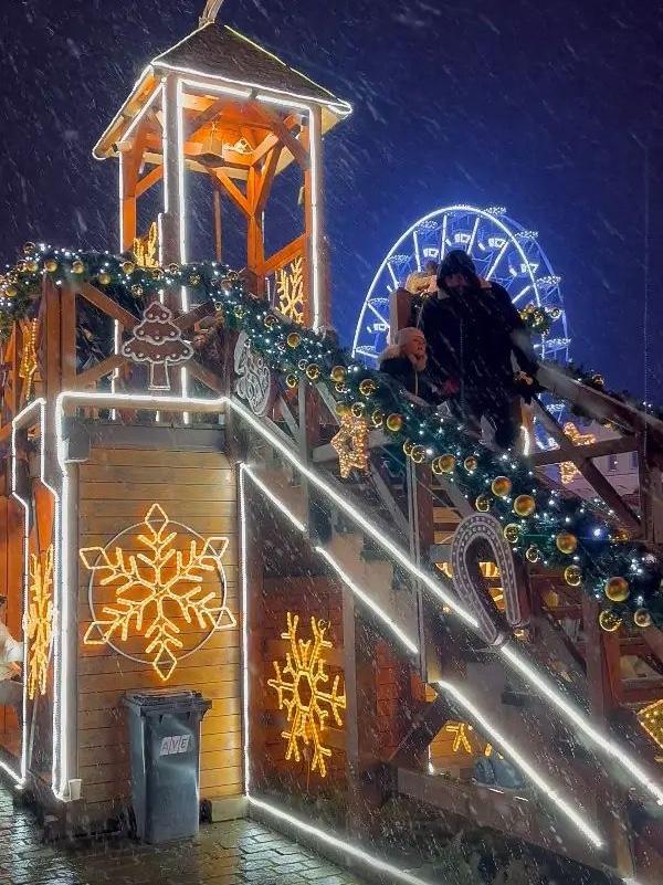 Ferris wheel and bell to ring at a Christmas market in Plzen