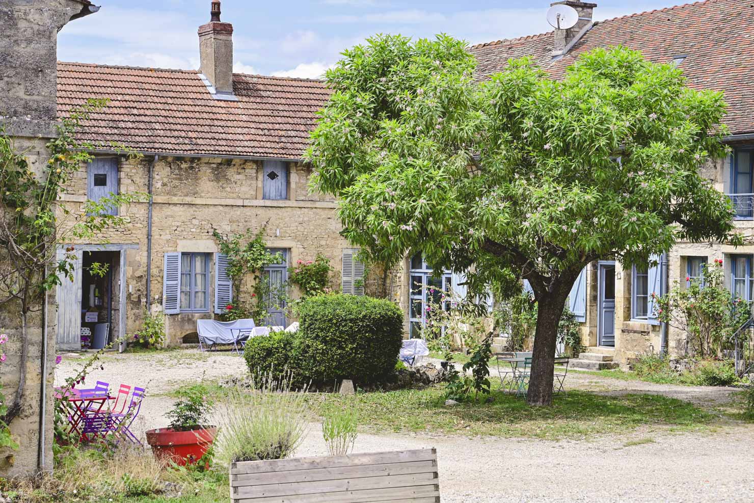 beautiful stone house with courtyard with a tree