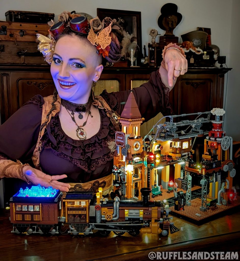 Ruffles & Steam wearing steampunk clothes with goggles showcasing two Lumibricks Steampunk set she built