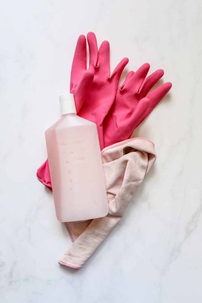 Plastic Bottle over Pink Rubber Gloves
