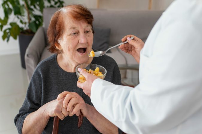 close-up-old-woman-being-fed