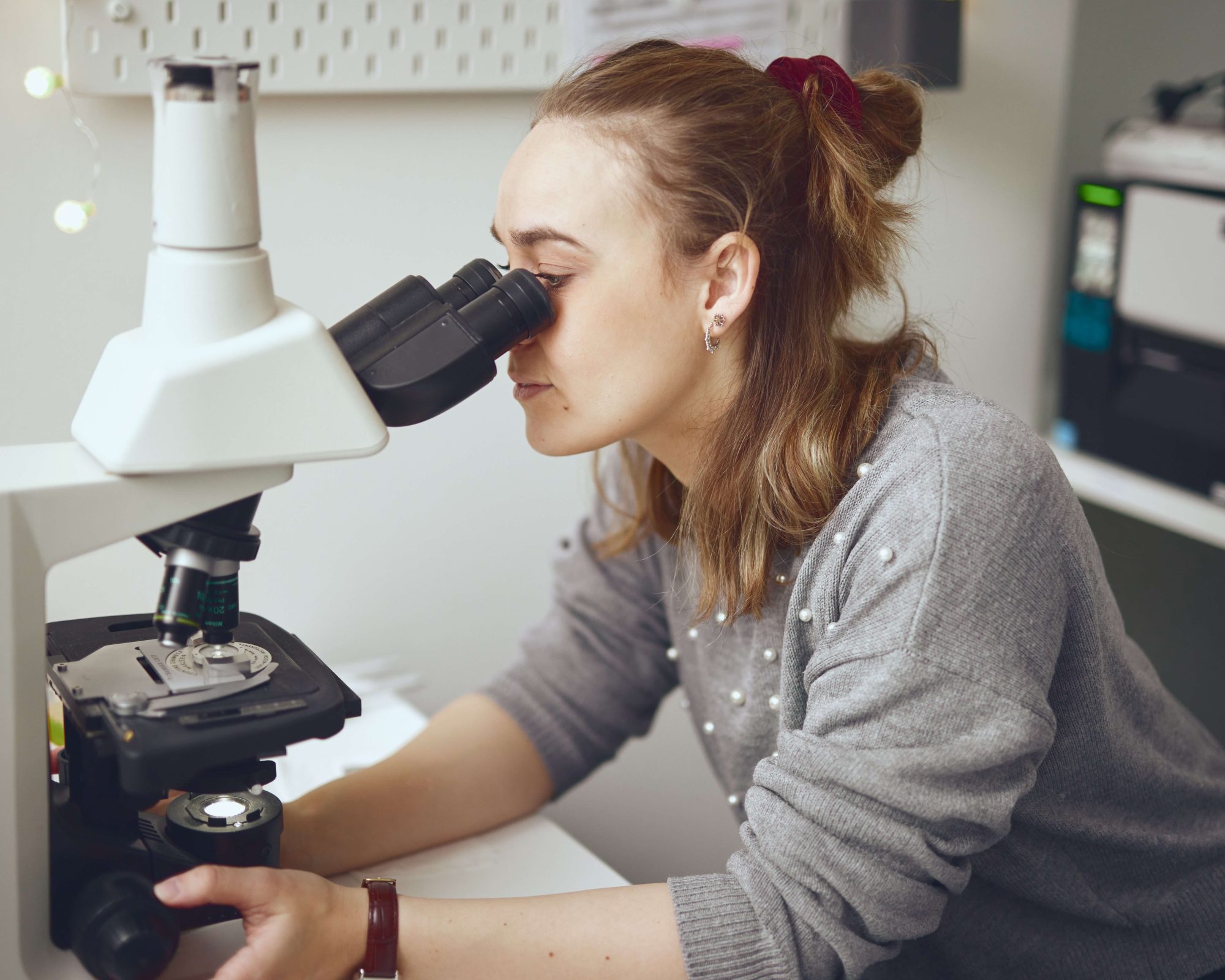 Looking into microscope