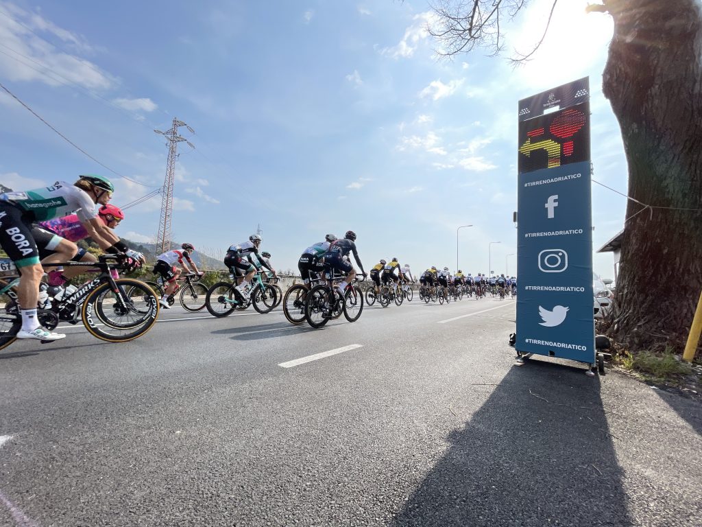 Tirreno-Adriatico 2022 using Safe Cycling Safety Sign (Mobile LED-sign for sporting events) with commercial space for event sponsors. 