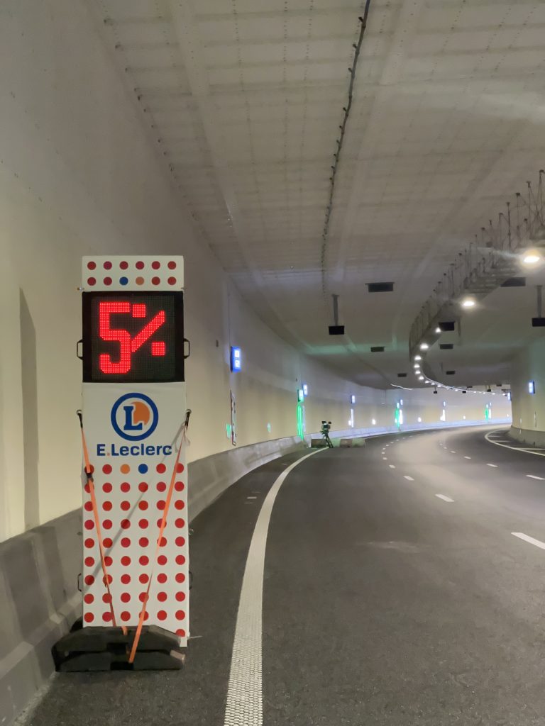 Mobile LED safety sign supplied by Safe Cycling for Tour de France Femmes 2024, displaying custom steepness of hill for race participants with commercial space for event sponsors.