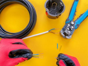 Electrician tools on orange background with copy space for text
