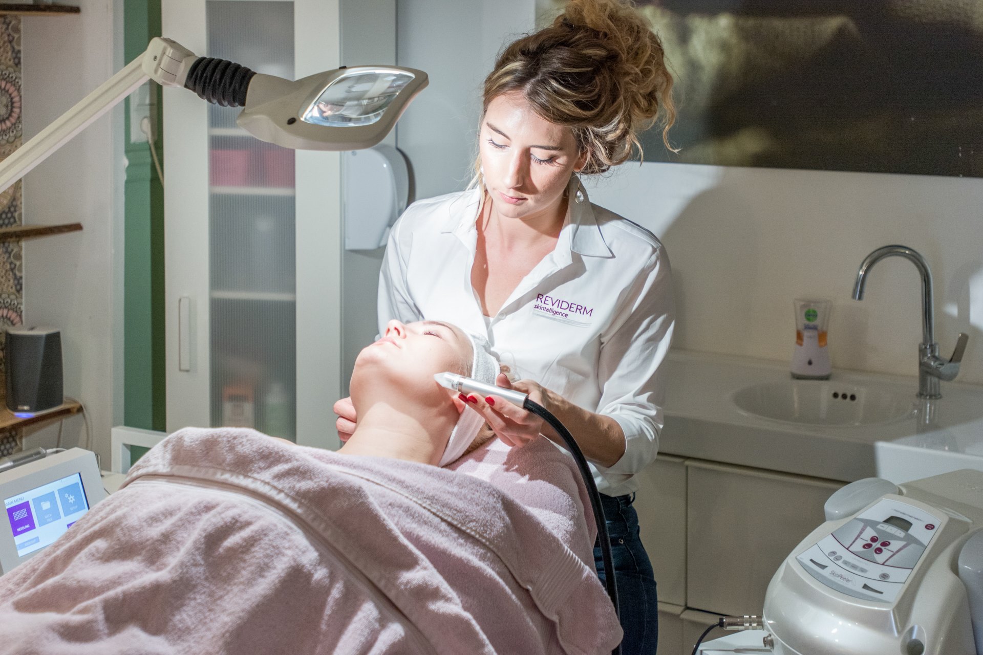 Schoonheidsspecialiste Jennifer Haak van Salon Beeldschoon aan het werk met het microdermabrasie beautyapparaat van Reviderm.