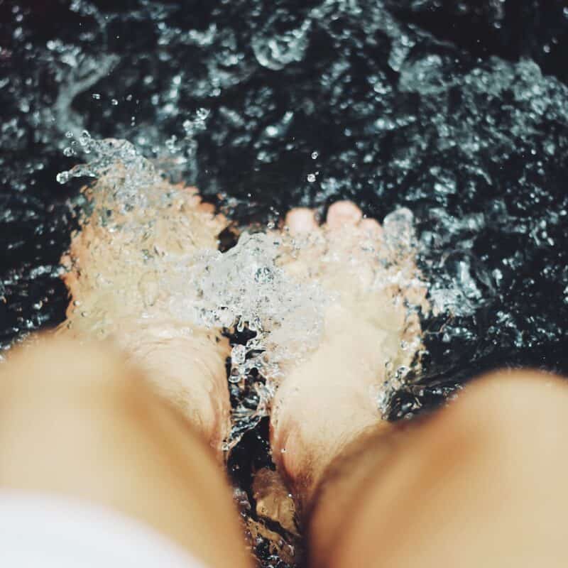 person putting his feet on water