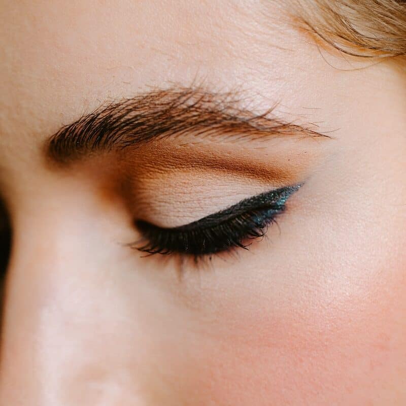 woman with red lipstick and black mascara