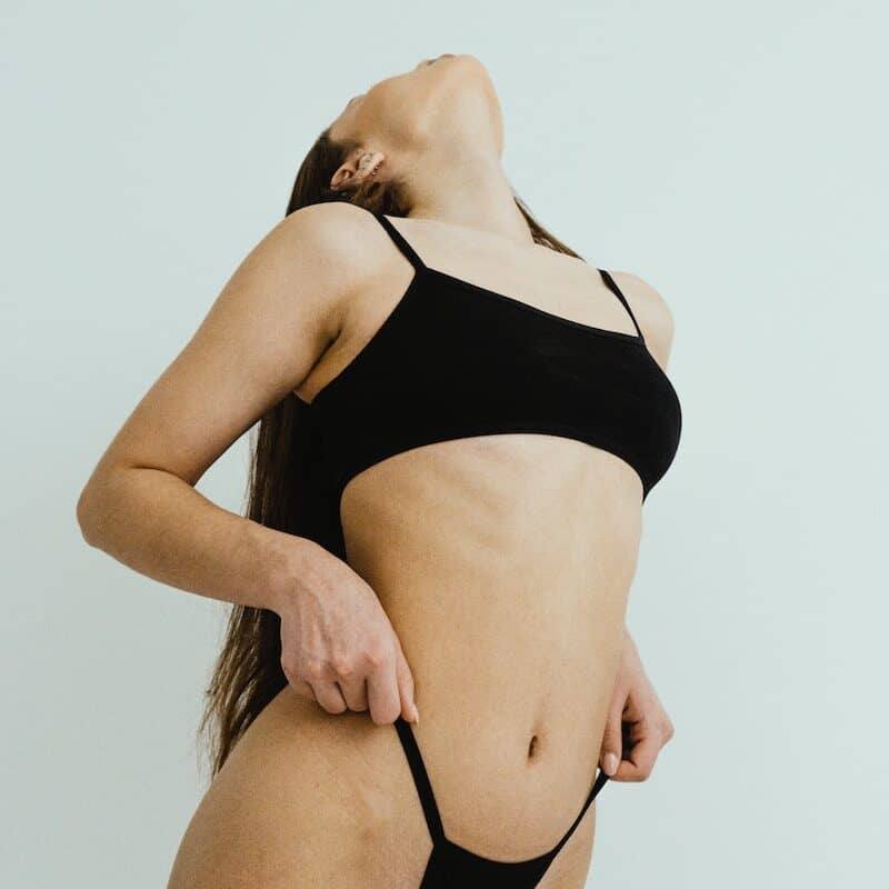 a woman in a black bikini posing for a picture