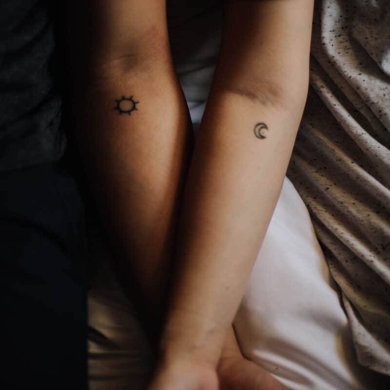 two persons showing their hand tattoos