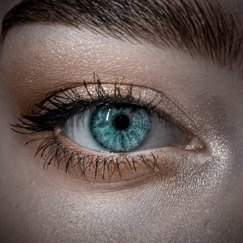 persons blue eyes in close up photography