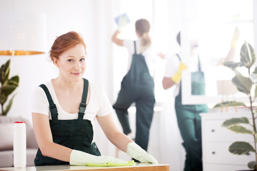 Cleaning lady dusting table