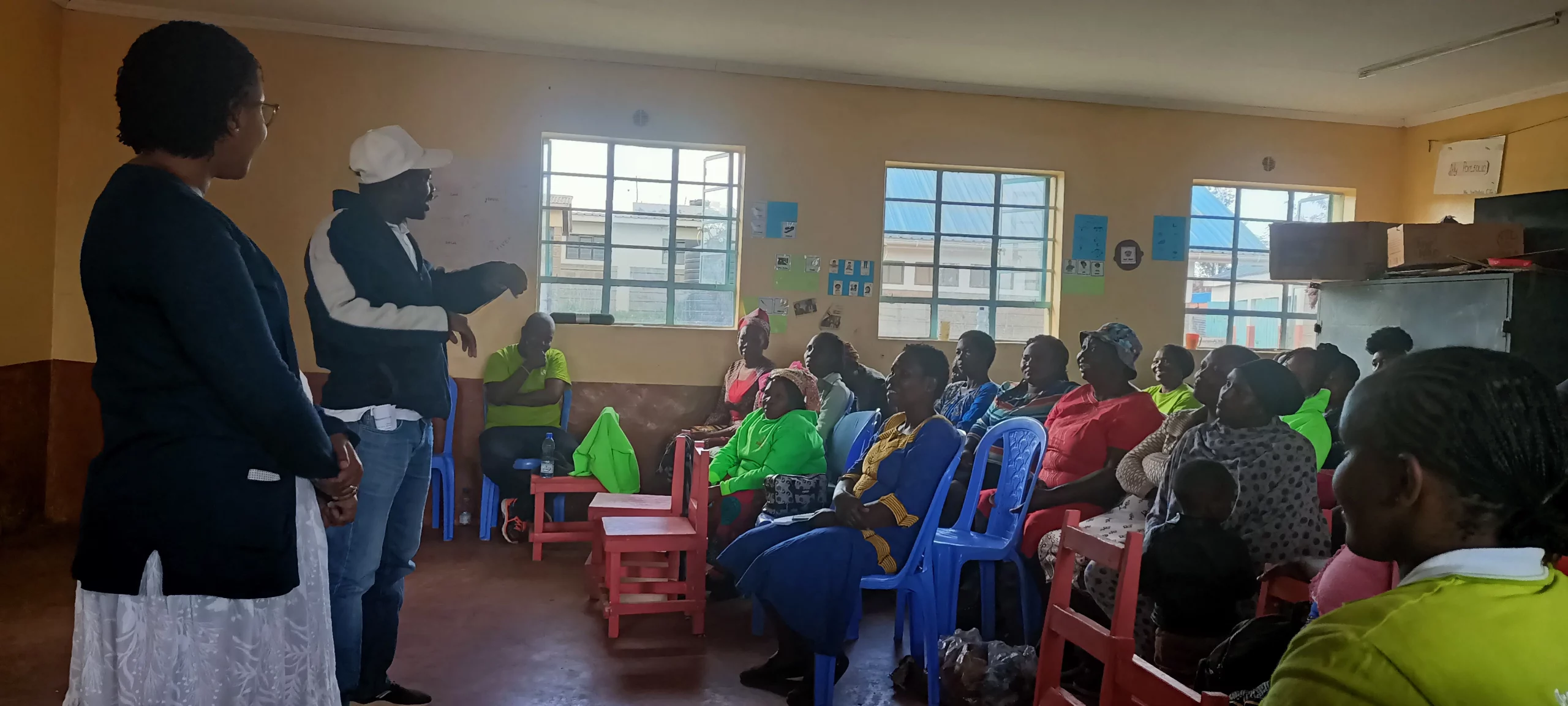 A parent sharing in a plenary session his experience of caring for a special needs child.