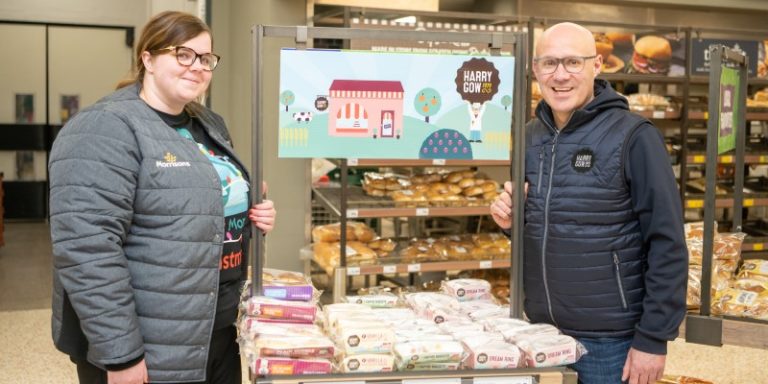 man and woman in front of bakery stand in supermarket