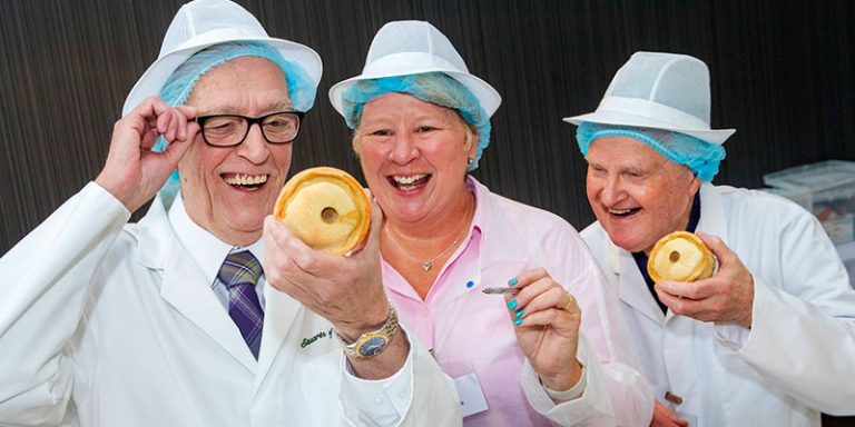 Judges examining pies