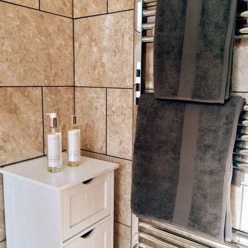 Inside the small, neutral bathroom in a county cottage