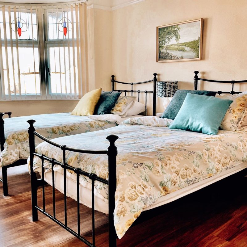 Bedroom with two single beds in Northumberland cottage