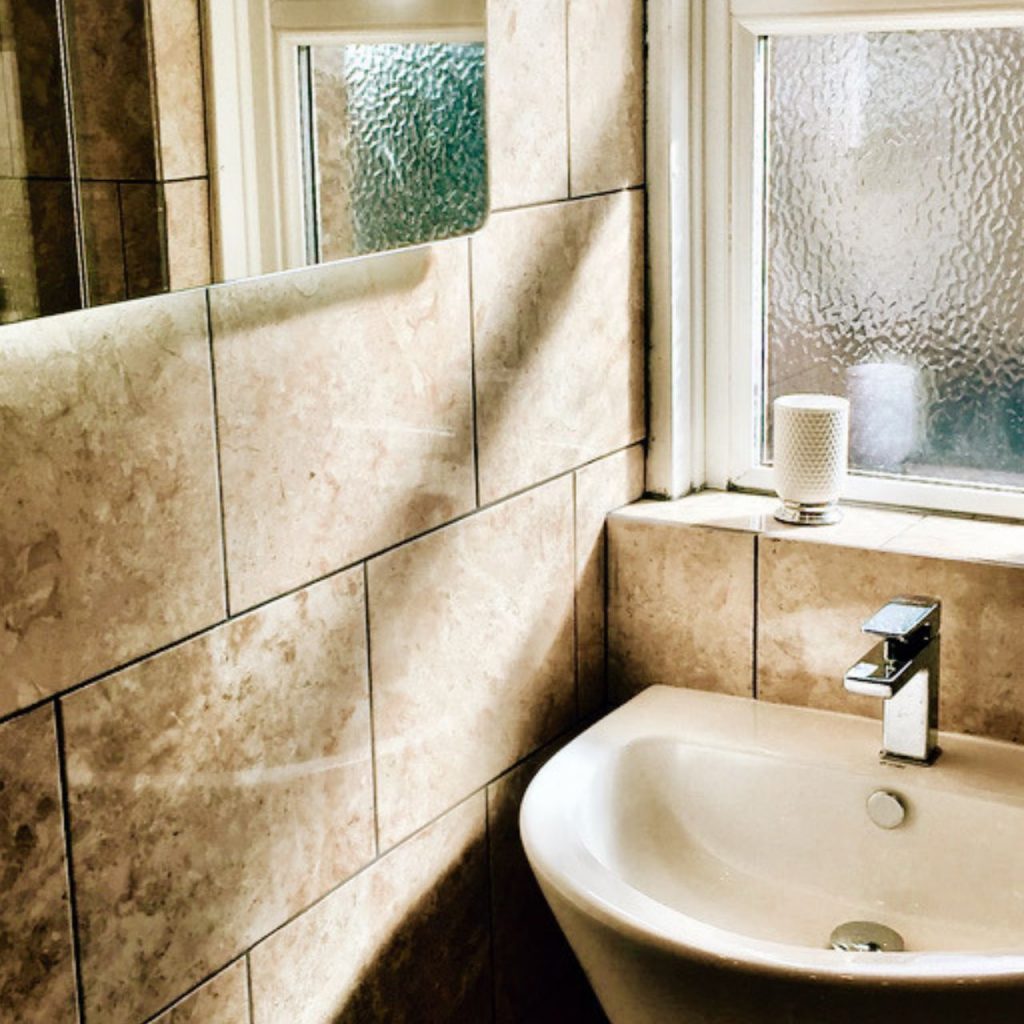 Tiled bathroom with sink in Kelvinside cottage