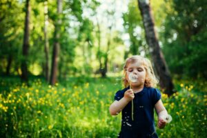 child with dandelion