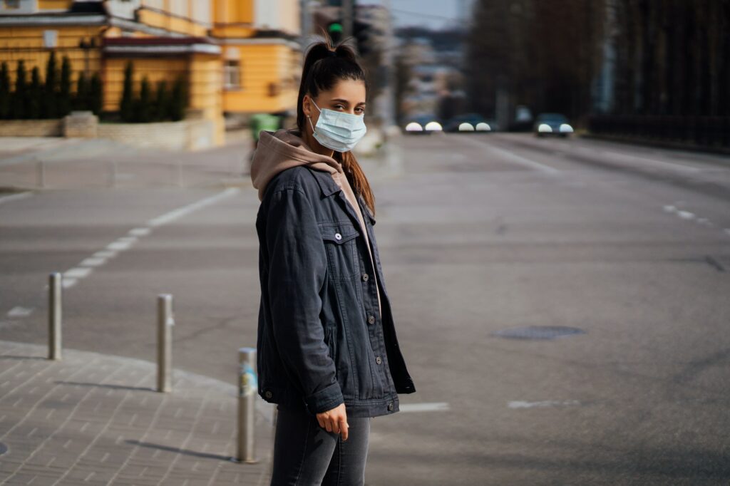 Close up of young woman with surgical mask on face