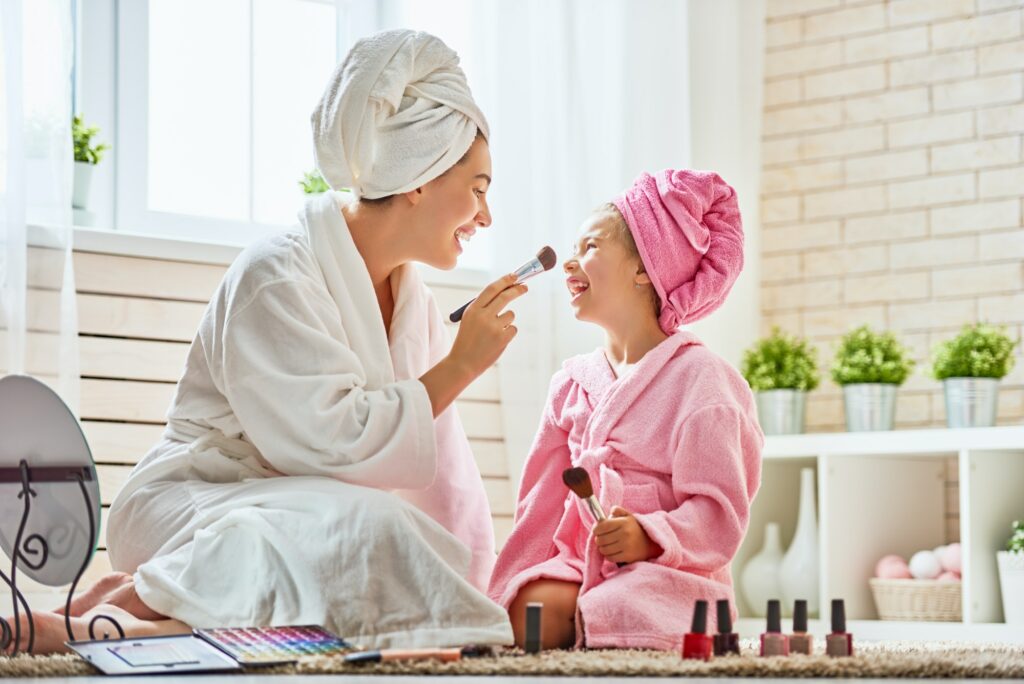 Mother and daughter are doing make up