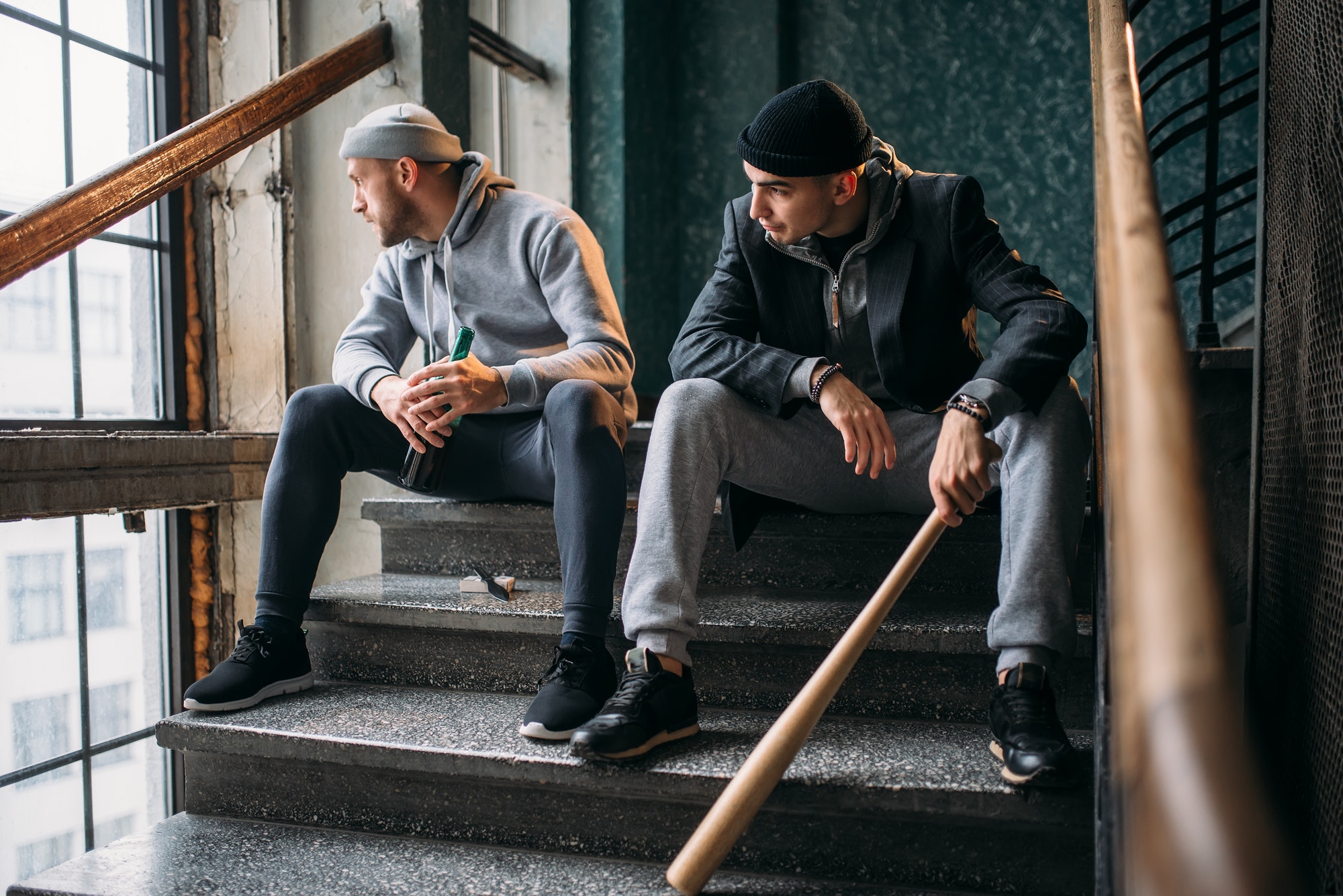 Two bandits with baseball bat waiting for victim