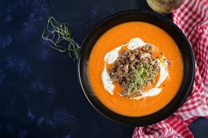 Delicious cream of pumpkin soup with roasted forcemeat made of beef minced meat