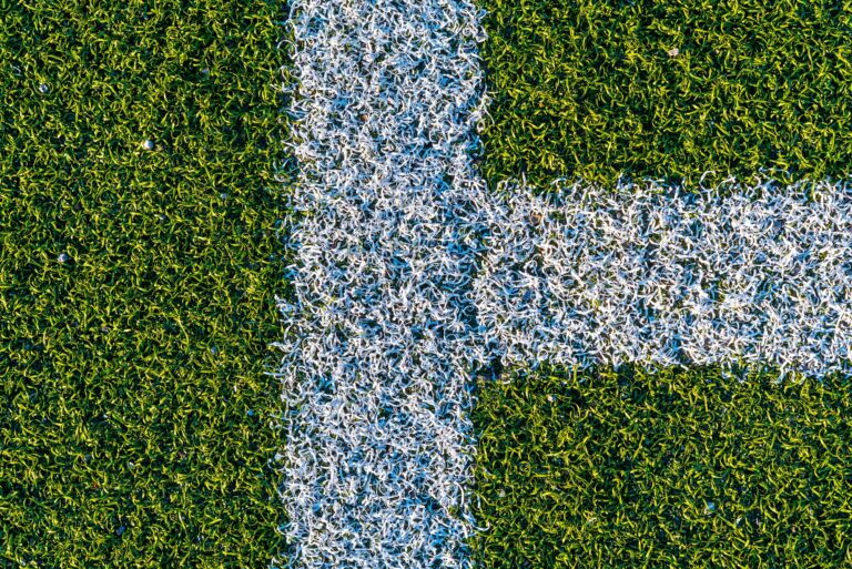 White lines on a green artificial football field