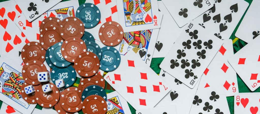 Gambling board game.Cards, chips, roulette.Gaming flat lay. Close-up of a card for playing poker on
