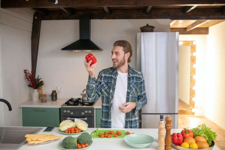 Man making a healthy salad in his kitchen