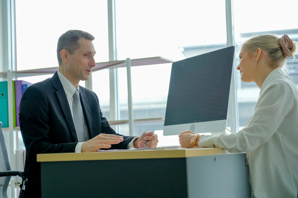 Business man talk with young woman during job interview for the company.