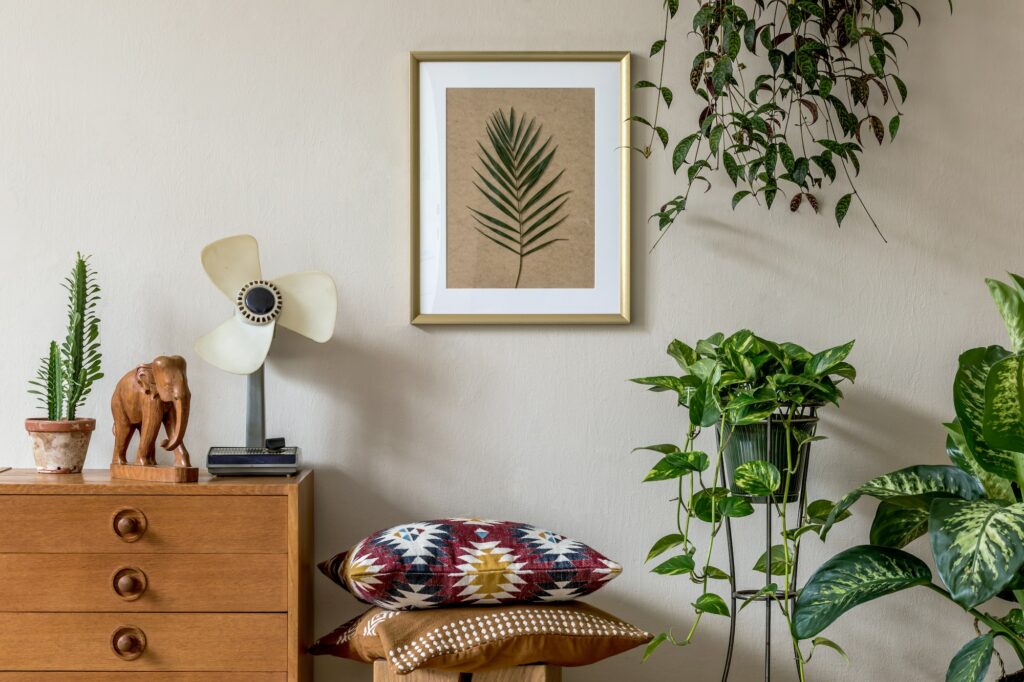 Stylish retro home staging of living room with gold mock up poster frame.