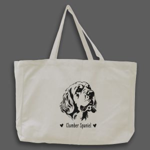 Foto av naturvit tygväska med svart illustration av hundhuvud av rasen Clumber Spaniel