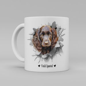 Vit keramikmugg med illustration av ett hundhuvud som "tittar ut genom" ett illustrerat hål. Hunden är av rasen Field Spaniel