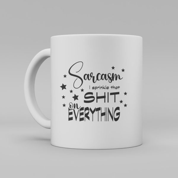 Vit keramikmugg med svart text på engelska: "Sarcasm I sprinkle that shit on everything"