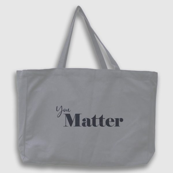 Foto på grå tygväska med svart engelsk text: "You matter"