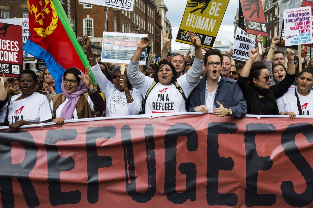 Protesters behind a banner chant as thousands march in central London, declaring that refugees are welcome in the UK Photograph: redorbital/Demotix/Corbis