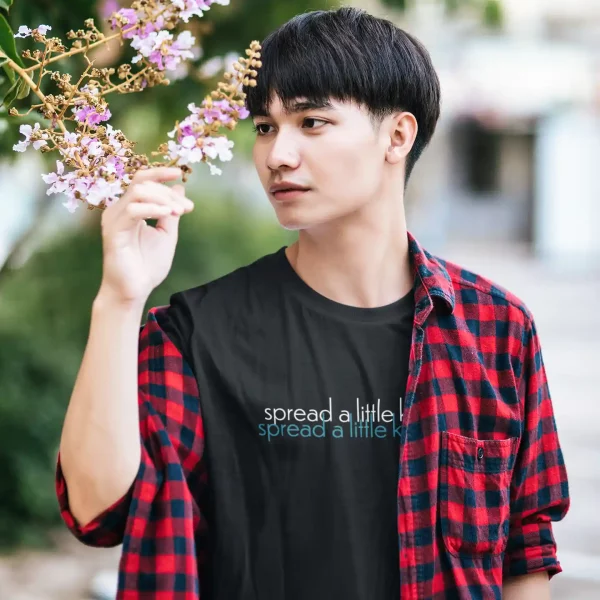 Man wearing a black Bella-Canvas t-shirt with Spread a little kindness print