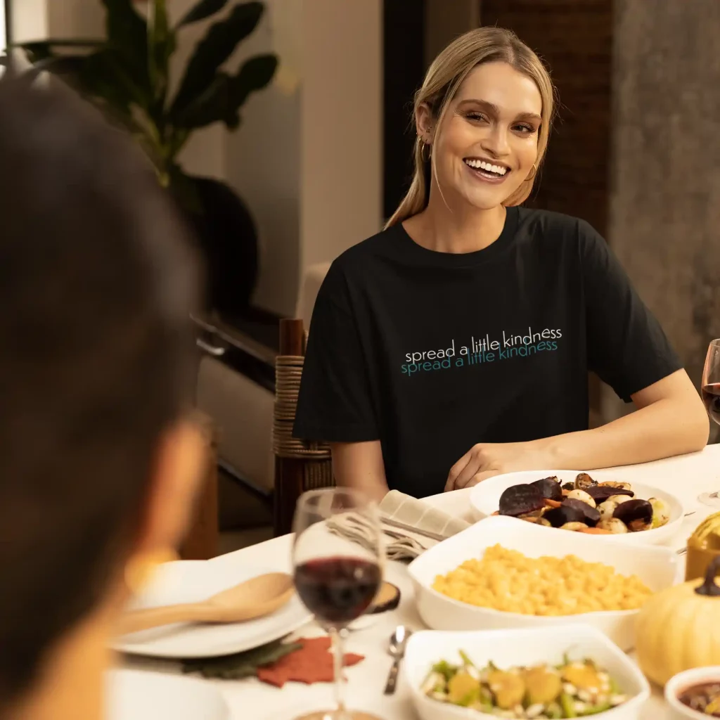 Woman wearing a black Bella-Canvas t-shirt with Spread a little kindness print