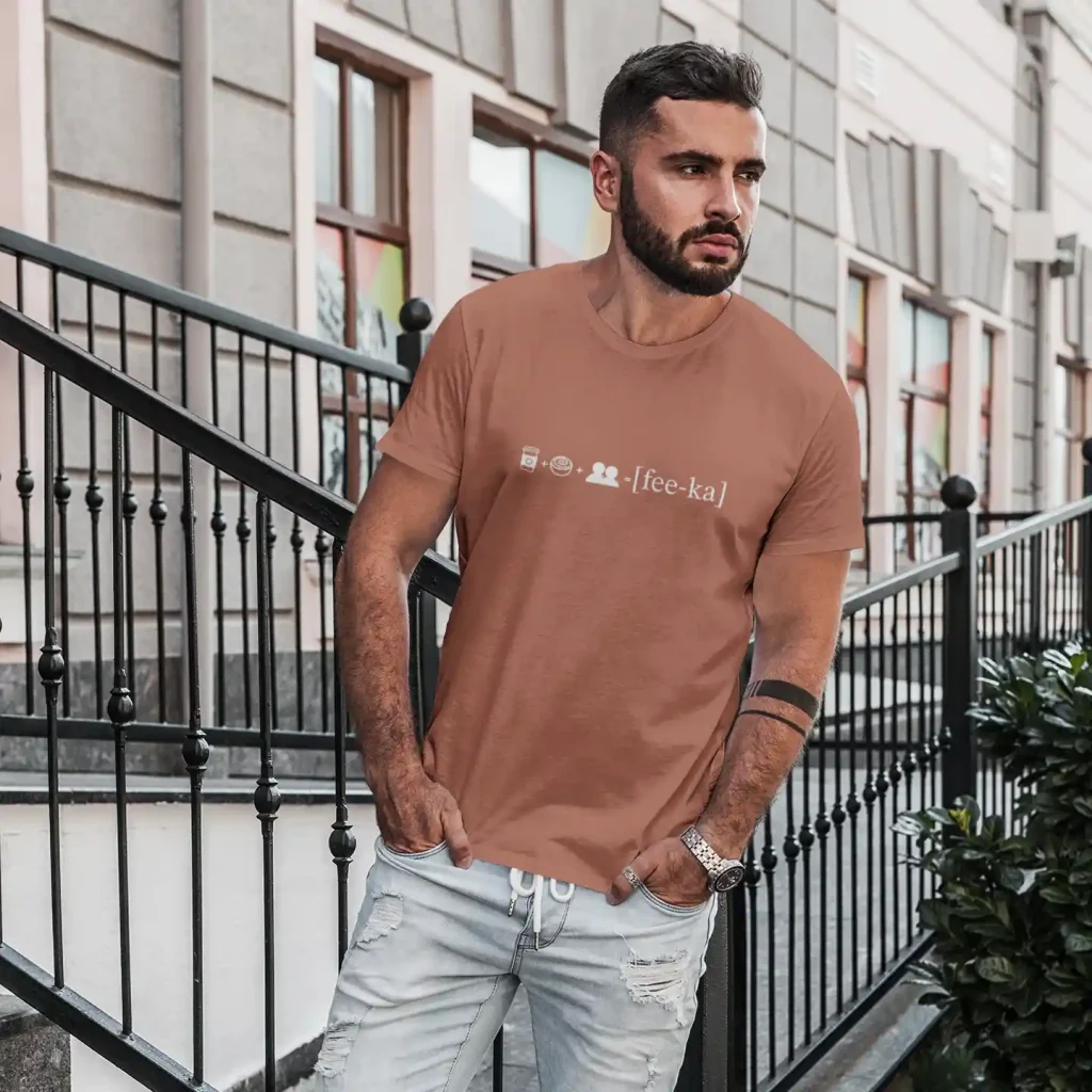 Man wearing a terracotta t-shirt with Fika Rebus print