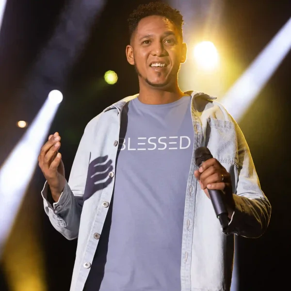 Young man wearing a lavender blue Bella-Canvas t-shirt with white Blessed print